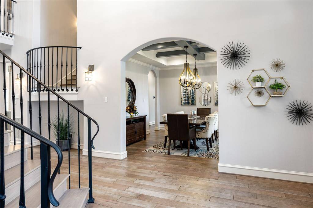 dual staircase visible on this shot. view of the formal dining and foyer