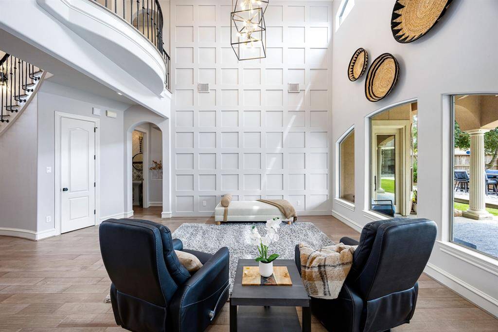 Family room with view of the pool through tall windows