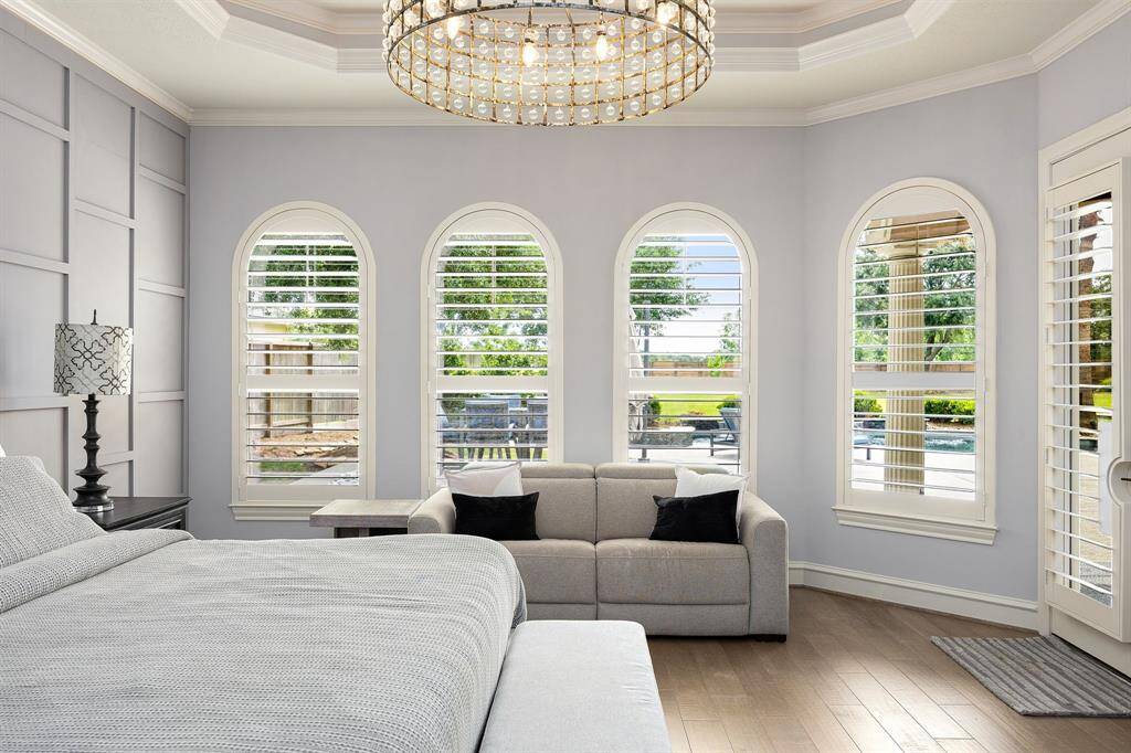 primary bedroom on first floor with panel accent wall