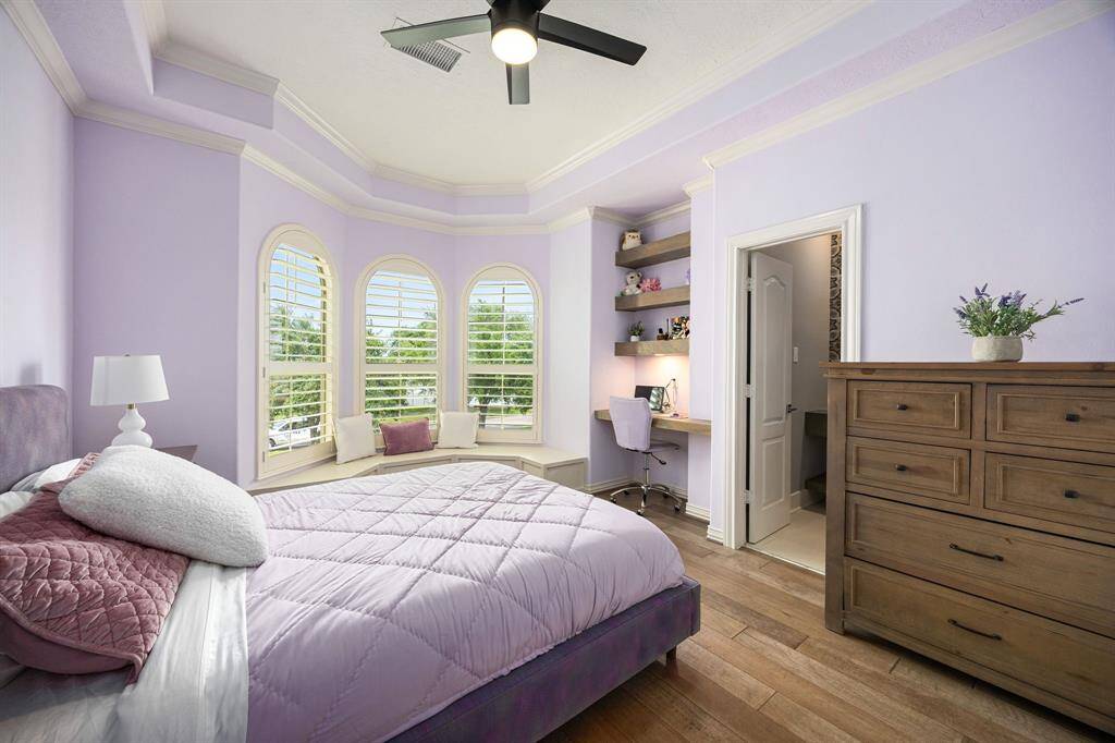 bedroom with bay windows and seating are and built-in shelves