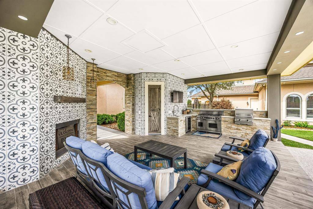 Exterior covered structure with fireplace and fully equipped kitchen