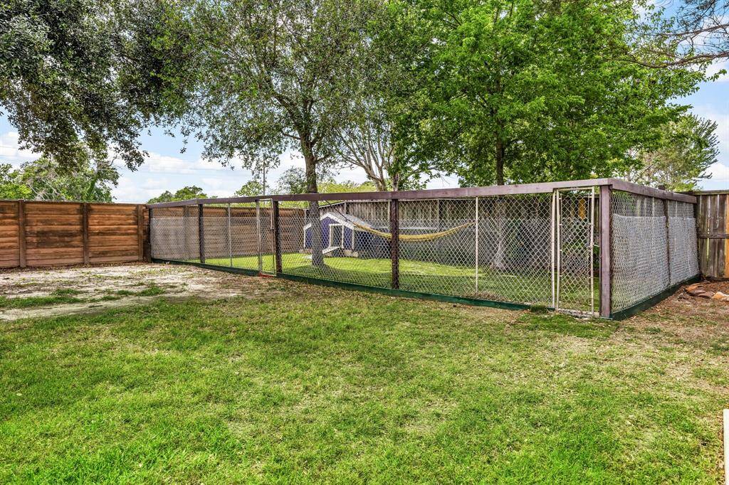 fenced dog run in the back