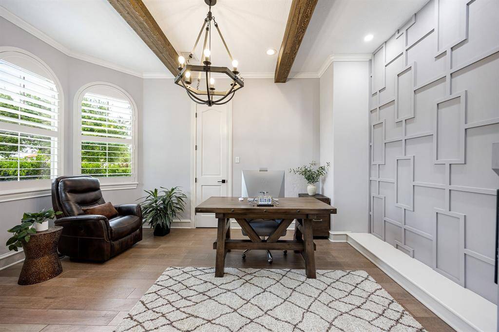 Inside view of office with panel wall, walk-in closet, beams on roof and modern luxury light fixtures