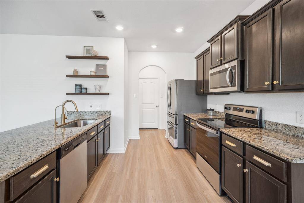 New fridge, new gold hardware, new gold faucets, new floating shelves, new paint.