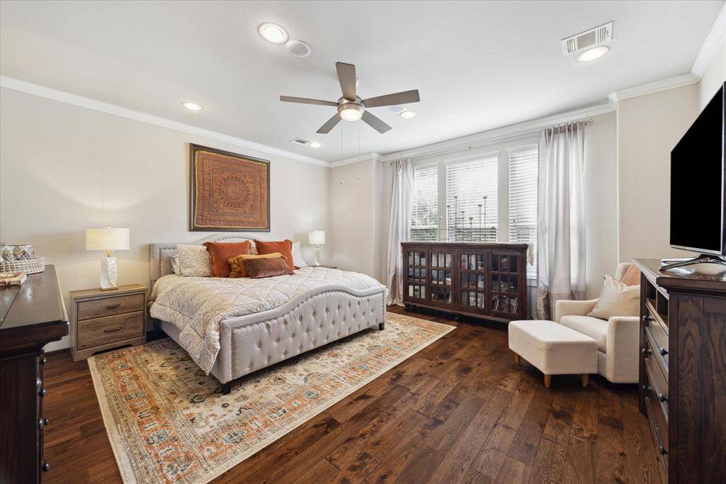 The spacious primary bedroom on the second floor features plenty of windows to flood the room with natural light.