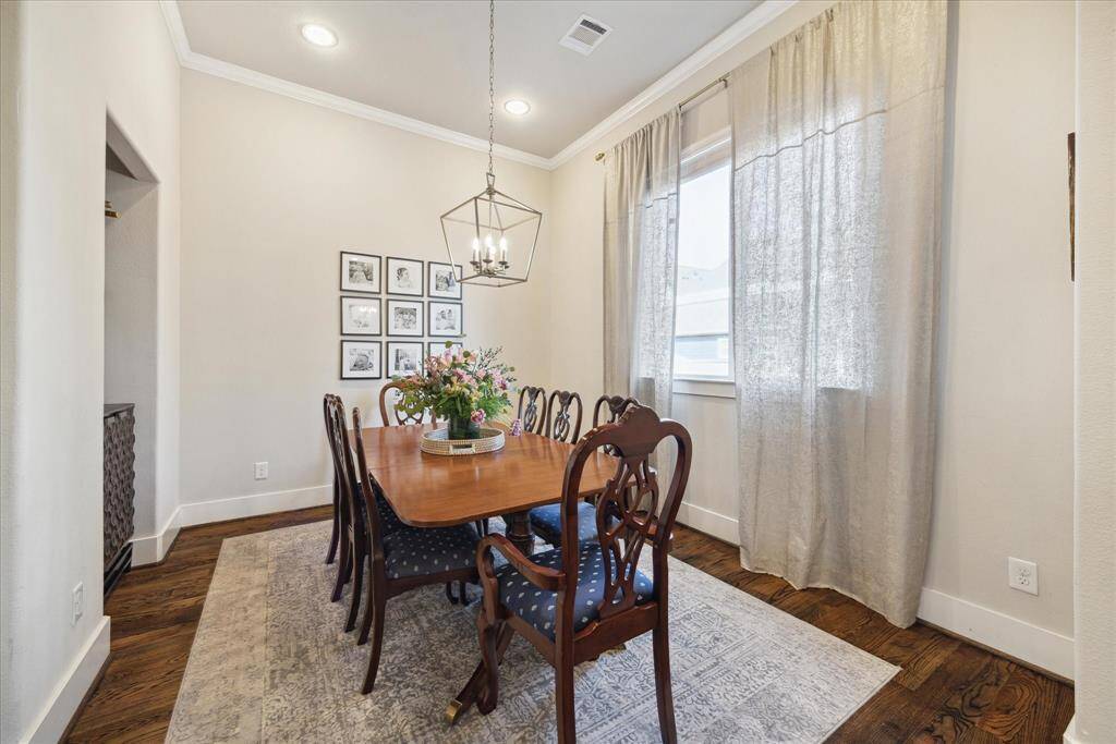 Dining area has a modern light fixture and a window to bring-in natural light.