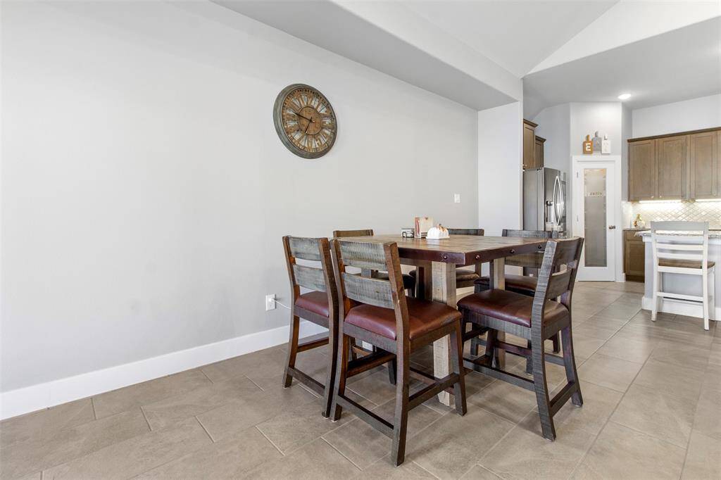 This dining area has tile floors and is right off the kitchen.