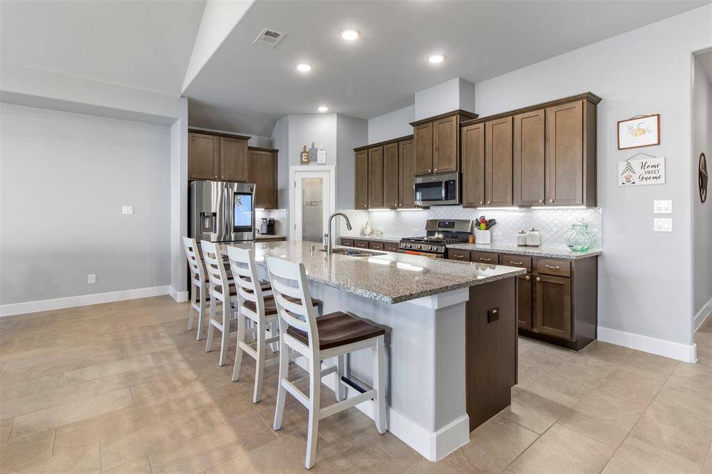 The kitchen features wood cabinets,creating a clean and timelessaesthetic.