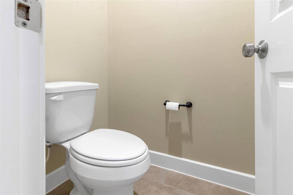 The toilet is behind an extra door for additional privacy.