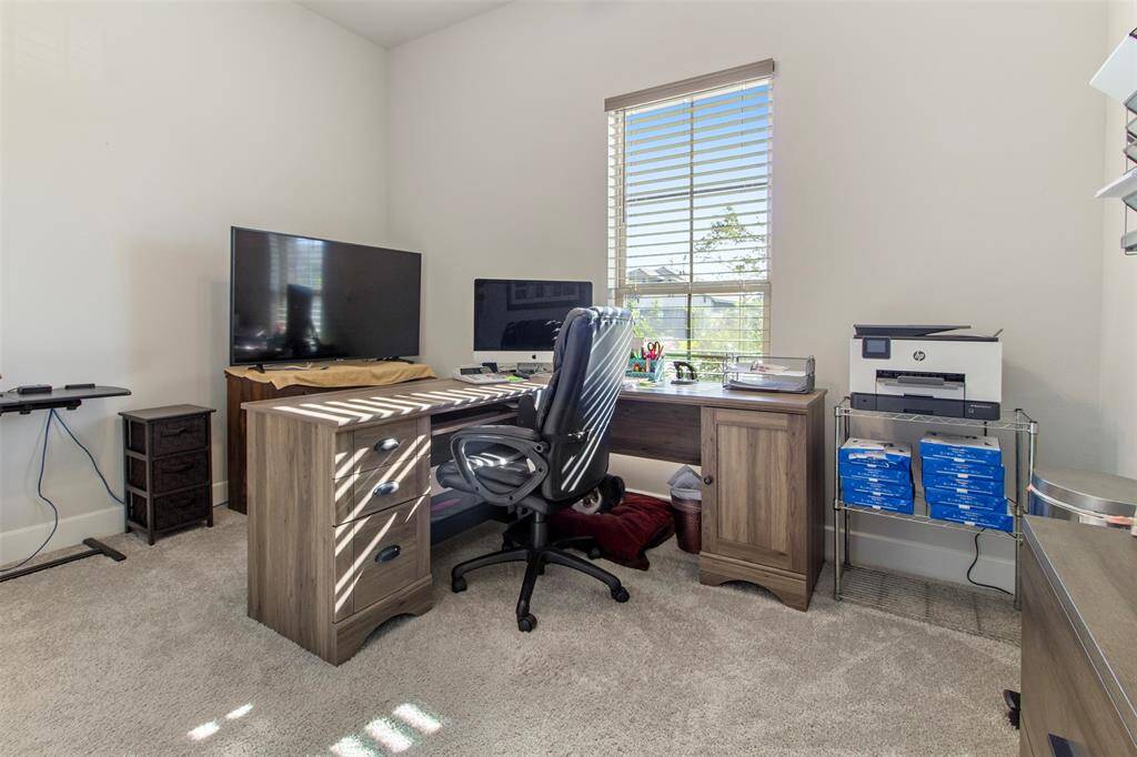 Third bedroom features awindow and plush carpet.