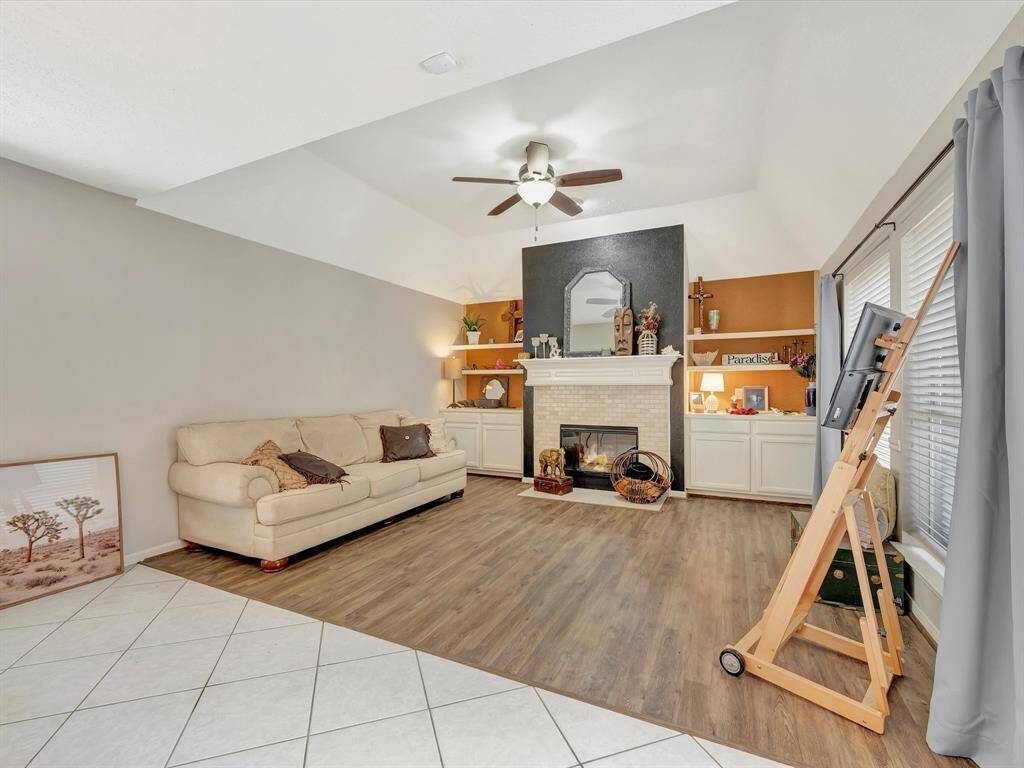 Welcome to the family room, featuring a cozy fireplace and custom built-ins, adding both warmth and functionality to this inviting space.