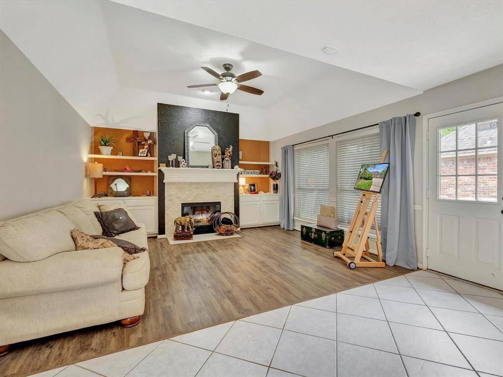 Enjoy this view of the den, bathed in natural light, with direct access to the backyard, offering a seamless connection between indoor comfort and outdoor relaxation.