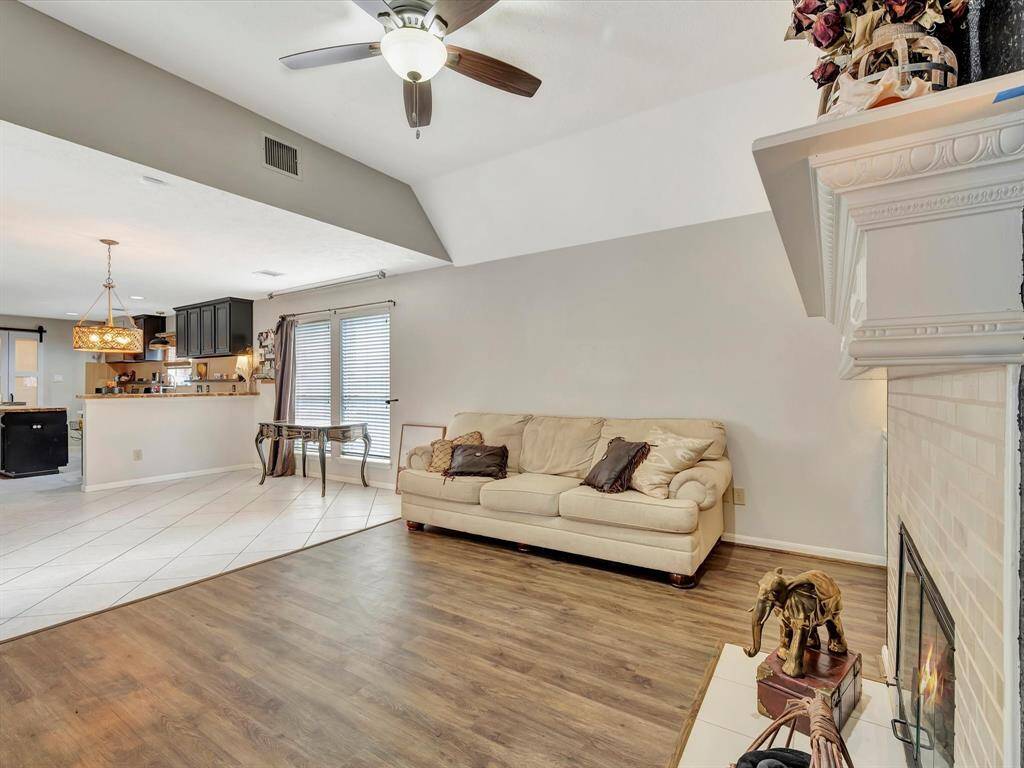 This view from the den overlooks the breakfast bar and kitchen island, creating a perfect connection between the living space and the heart of the home