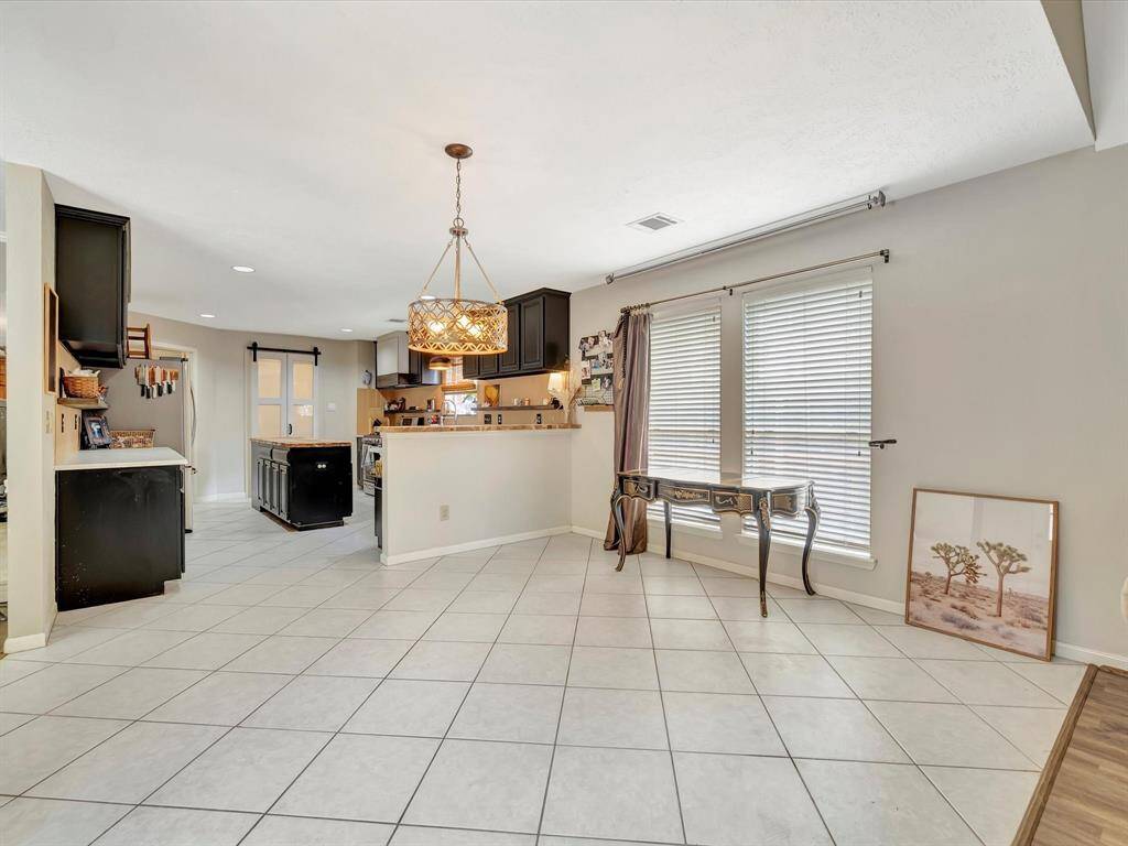 Bright and welcoming breakfast area, perfectly situated to offer a cozy space for morning meals, with easy access to both the kitchen and den areas