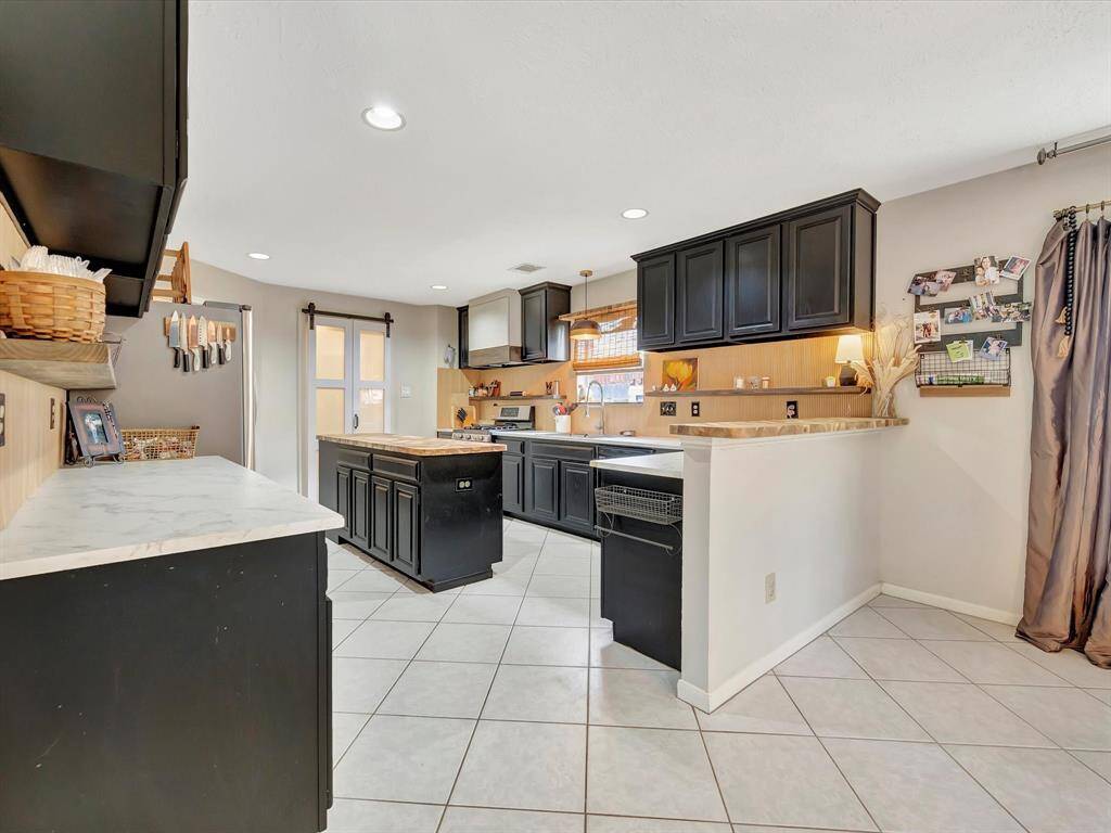 Ample countertop space complemented by stylish black cabinets, offering both functionality and a modern aesthetic to the kitchen.