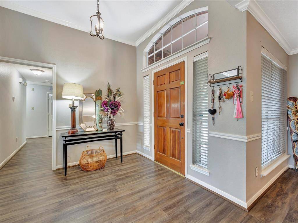 welcoming interior filled with natural light., to right is the formal dining room. The hallway leads to 3 substantial bedrooms