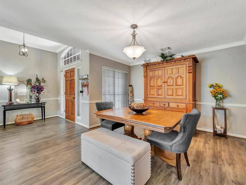 Open concept living, formal dining room with stylish chair rail