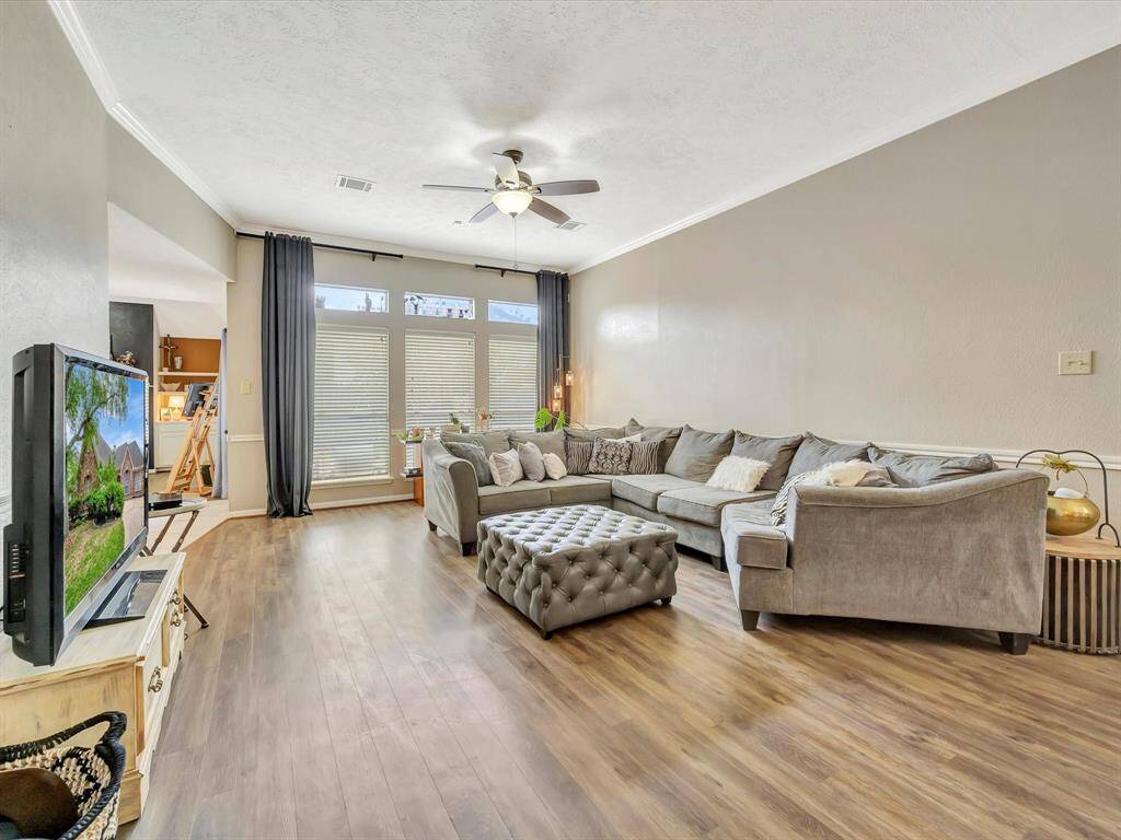 Step into this stunning home featuring a huge open-concept living room, flooded with natural light from expansive windows that offer beautiful views and a warm, inviting atmosphere—perfect for entertaining or relaxing in style