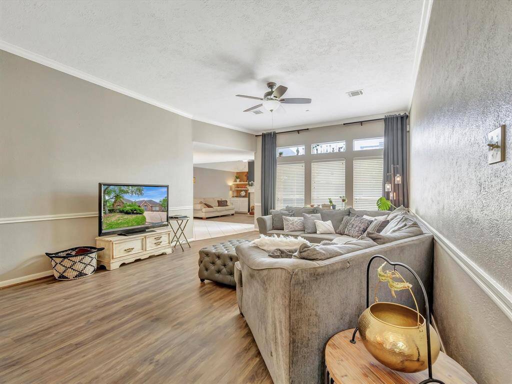 Spacious open-concept living room seamlessly flows into the den/family room with easy access to the den—creating the perfect layout for both casual gatherings and relaxing downtime.