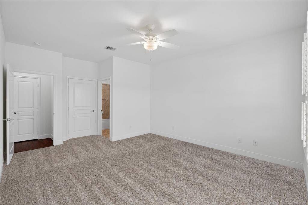 Another look at the spacious guest suite, thoughtfully positioned for privacy—tucked away from the owner's suite on the opposite side of the home. With its en-suite bath, it easily functions as a second primary suite.
