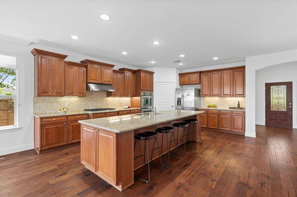Ample cabinetry provides plenty of space for all your dishes, while the walk-in pantry offers even more storage for added convenience.