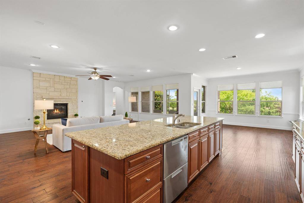 The open-concept design seamlessly flows from the gathering room into the dining area and kitchen, creating a perfect layout for effortless entertaining.