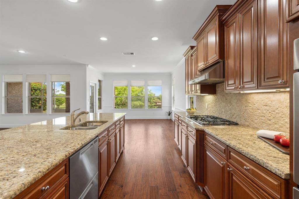 A plethora of gleaming granite surfaces adds luxury and sophistication to the space.