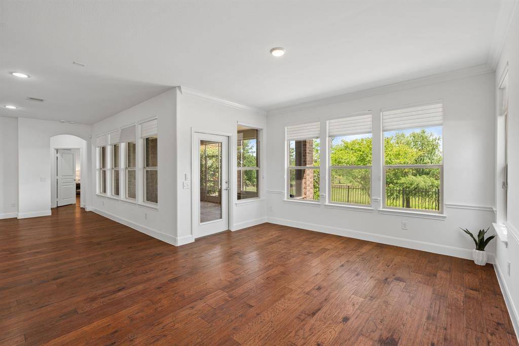 This door opens to the serene screened-in porch, with the entry to the owner's suite just beyond, offering a perfect blend of indoor and outdoor living.