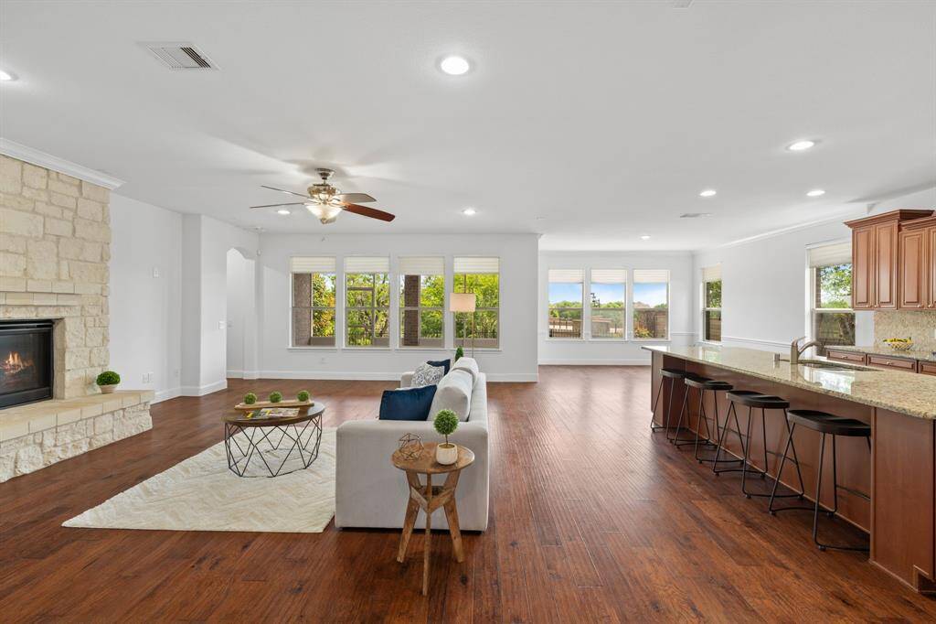The gathering room features a wall of windows that bathe the space in natural light, creating a warm and inviting atmosphere. The gas log fireplace takes center stage, adding both charm and comfort to the room.