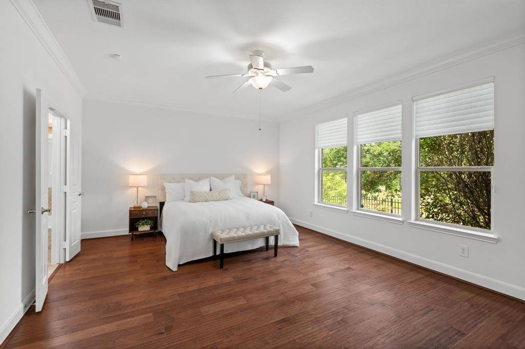 The owner’s suite is generously sized, offering ample space for a king bed, two nightstands, a dresser, chest, and more, creating a comfortable and luxurious retreat.