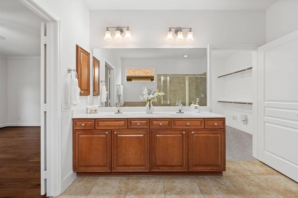 A small window above the tub invites natural light, creating a bright and airy atmosphere in the bath.