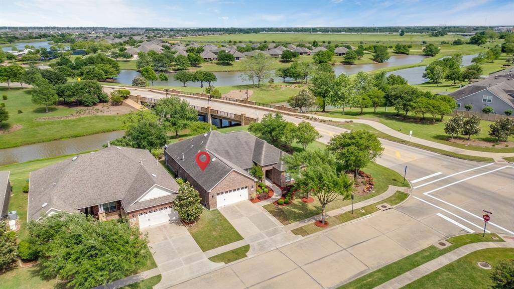 Enjoy views of mature trees, Rabbs Bayou, and the tranquil Del Webb Lake, creating a peaceful and picturesque backdrop.