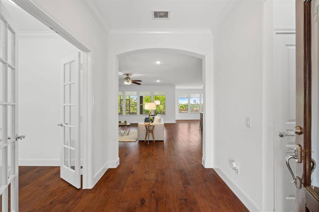 Step inside to warm-toned wood flooring and an open, welcoming entry—an ideal space for a statement mirror or charming entry table to set the tone for the home.