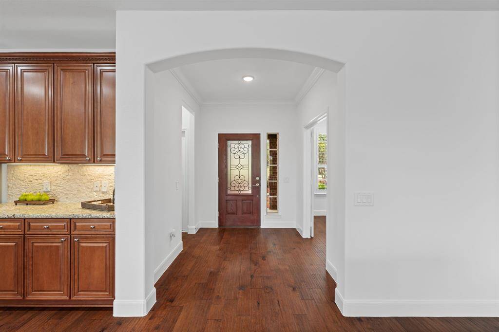 Freshly painted in Sherwin-Williams Snowbound, the home exudes a crisp, updated feel—complemented by beautifully refreshed doors, crown molding, MUD bench, and baseboards for a clean, modern look.
