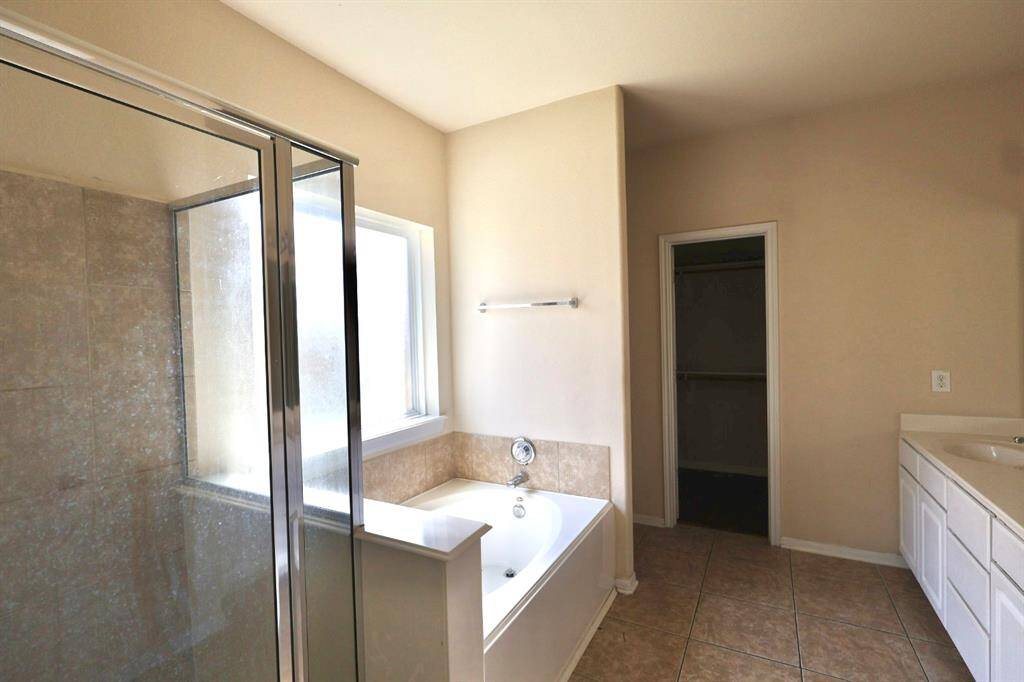 Primary bathroom with separate tub and shower