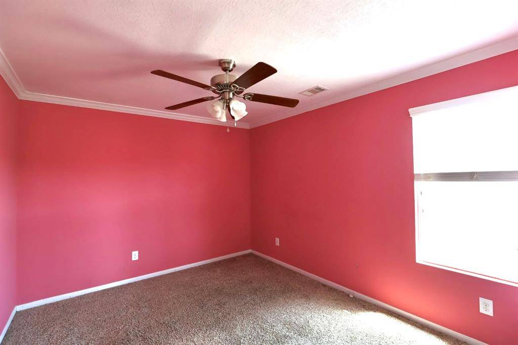 Upstairs secondary bedroom with carpet and cheerful paint