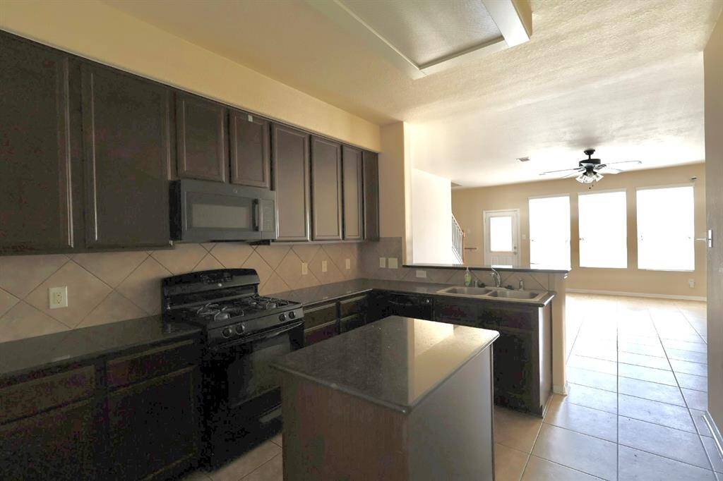 Granite countertops, lots of cabinets and a island