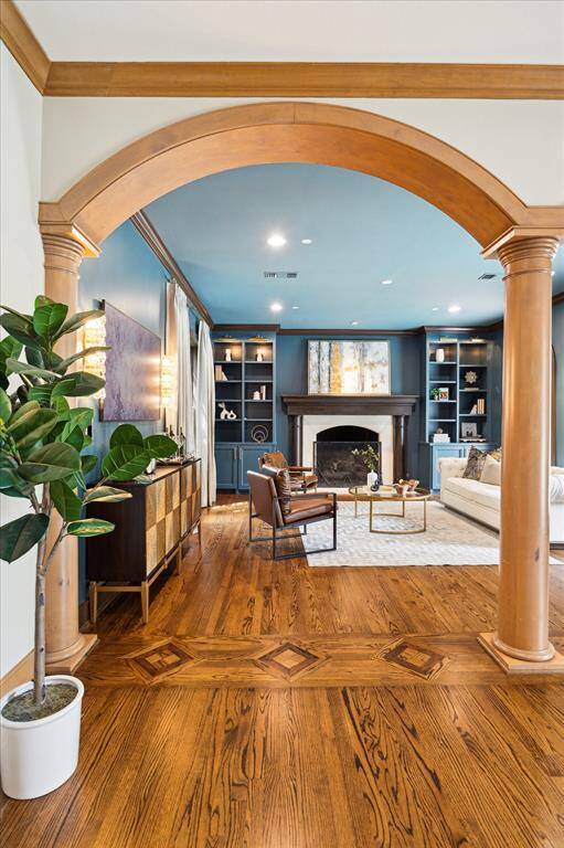 Statement archways with sculpted columns lead into the richly appointed living room, setting the tone for elevated entertaining.