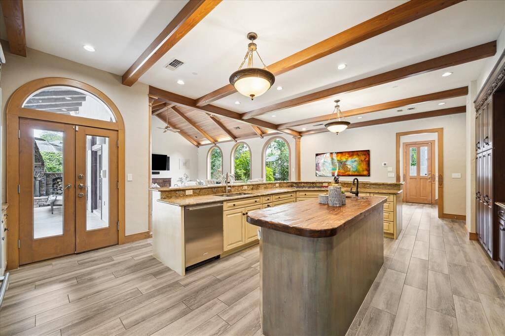 The chef’s kitchen is an entertainer’s dream, with dual islands, custom cabinetry, and seamless views into the great room and outdoors.