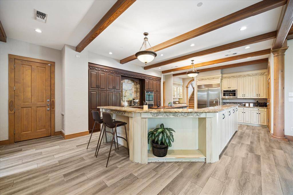 A perfect blend of luxury and function—note the thoughtful layout, breakfast bar seating, and integrated storage solutions.