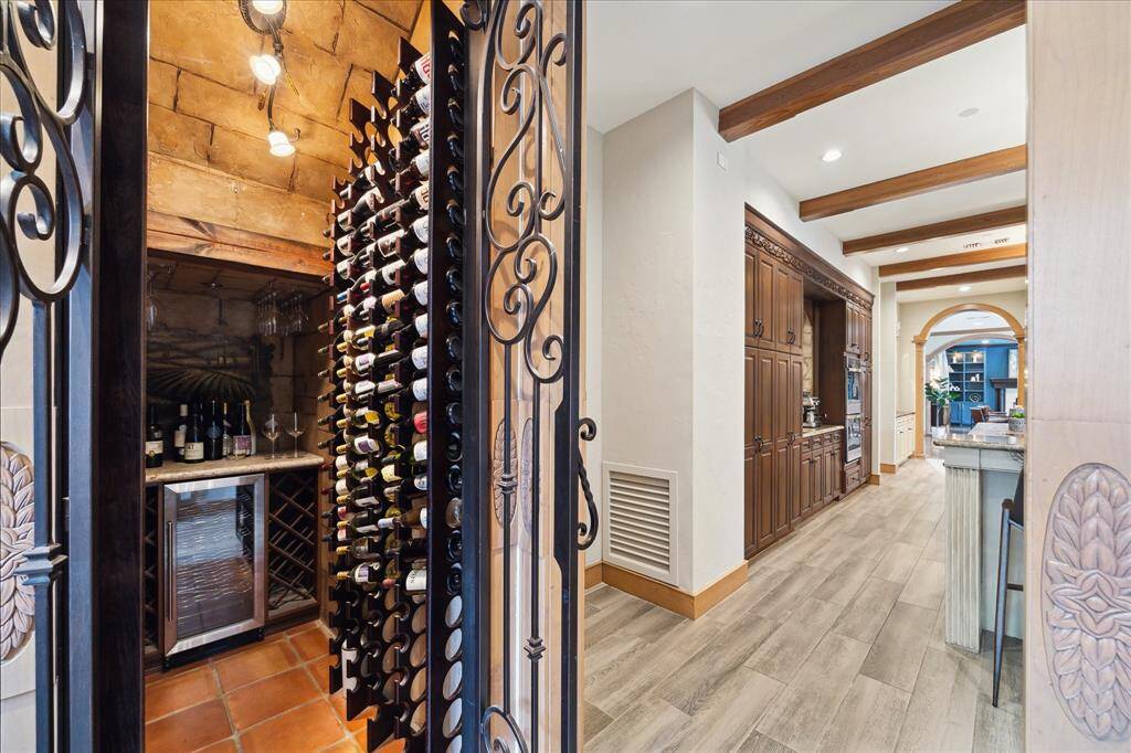Wine room with iron doors and stone detail offers a private, European-inspired tasting experience.