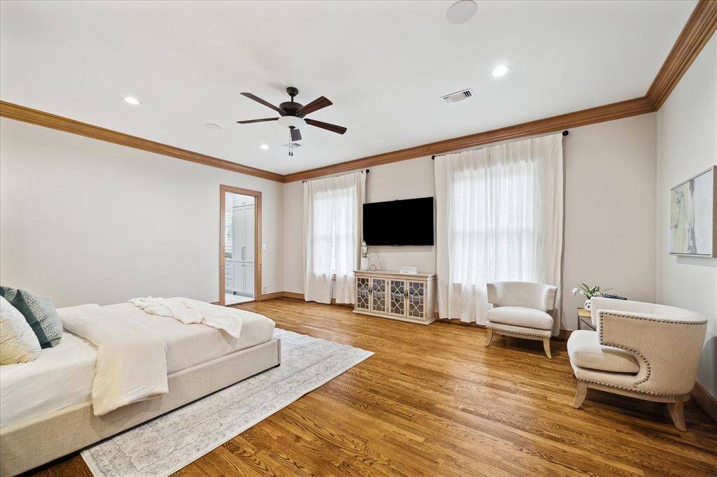 A luxurious retreat: the primary suite showcases soft neutral tones, custom millwork, and dual walk-in closets.