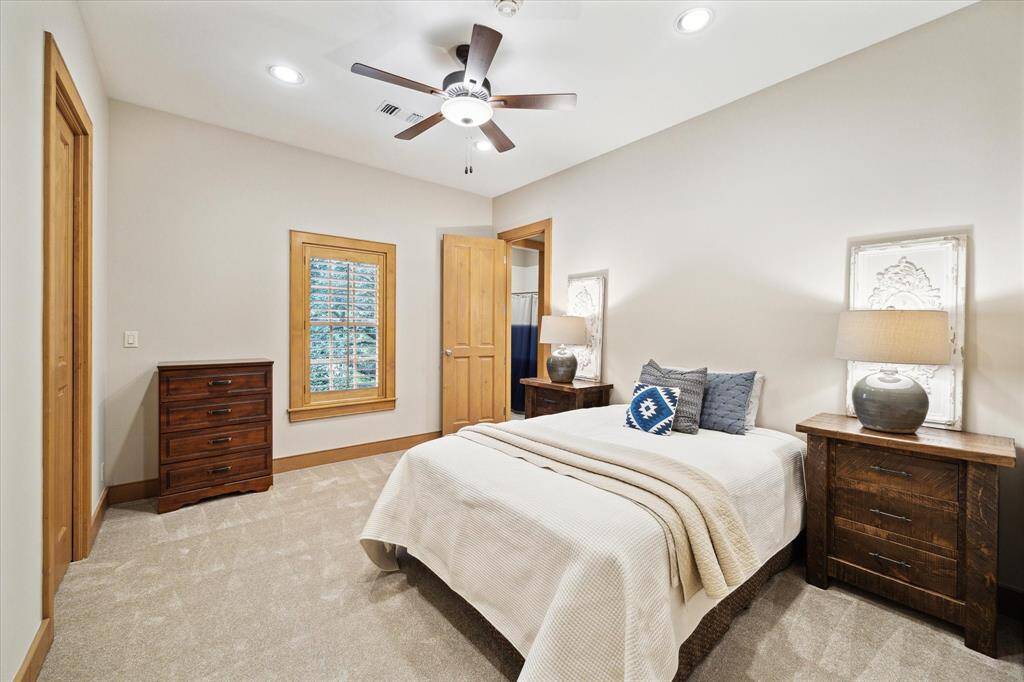 Warm wood trim and neutral tones create a restful guest suite, complete with an ensuite bath