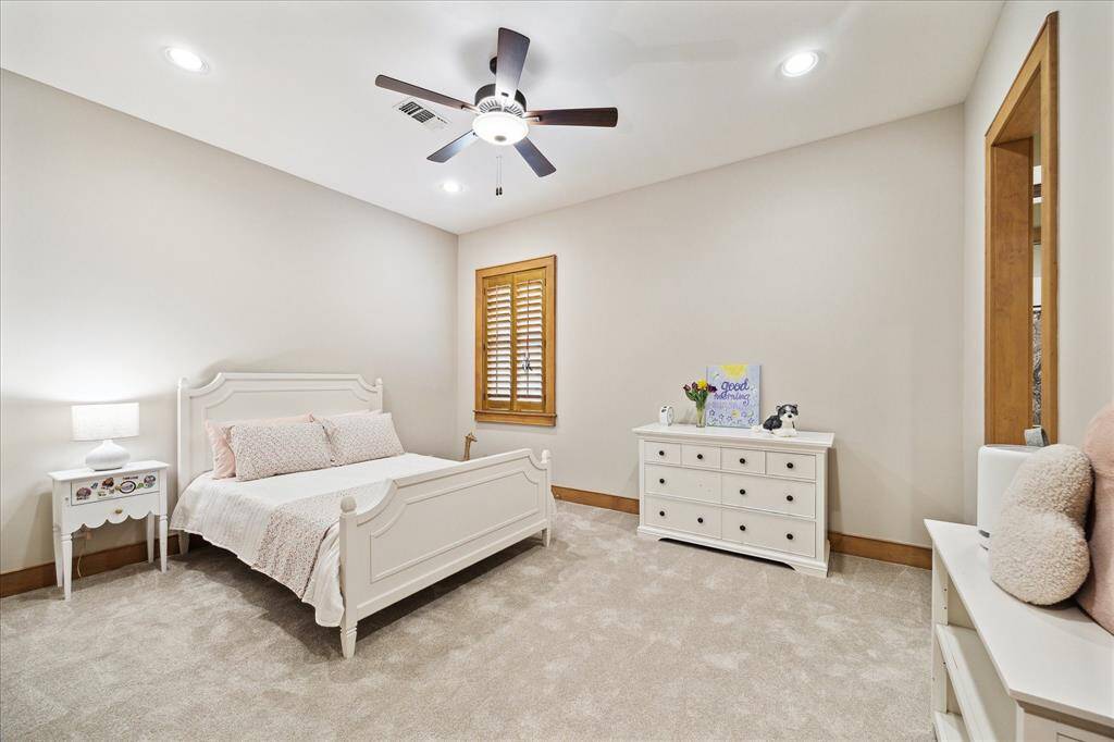 Crisp and bright, this secondary bedroom offers peaceful privacy with plush carpet, soft lighting, and generous proportions.
