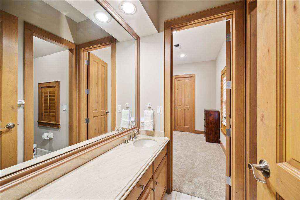 Secondary baths feature granite or marble counters, custom cabinets, and updated tilework throughout.