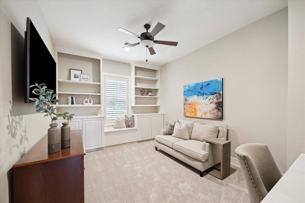 Flexible first-floor space just off kitchen  ideal for playroom, or private office, featuring custom built-ins and great natural light.