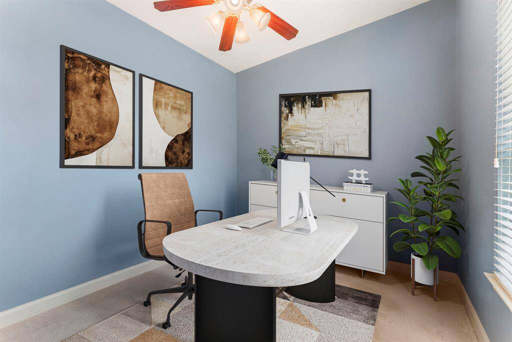 Secondary bedroom virtually staged as a home office.