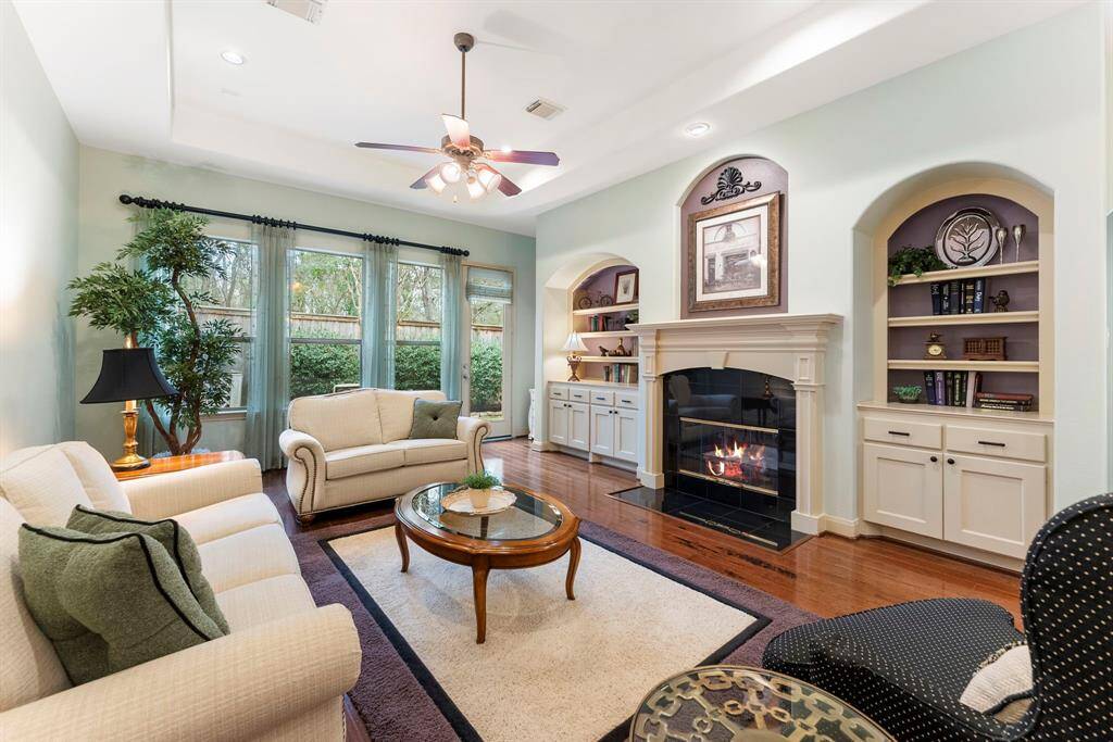 The family room showcases a gas log fire place and built-in cabinets.