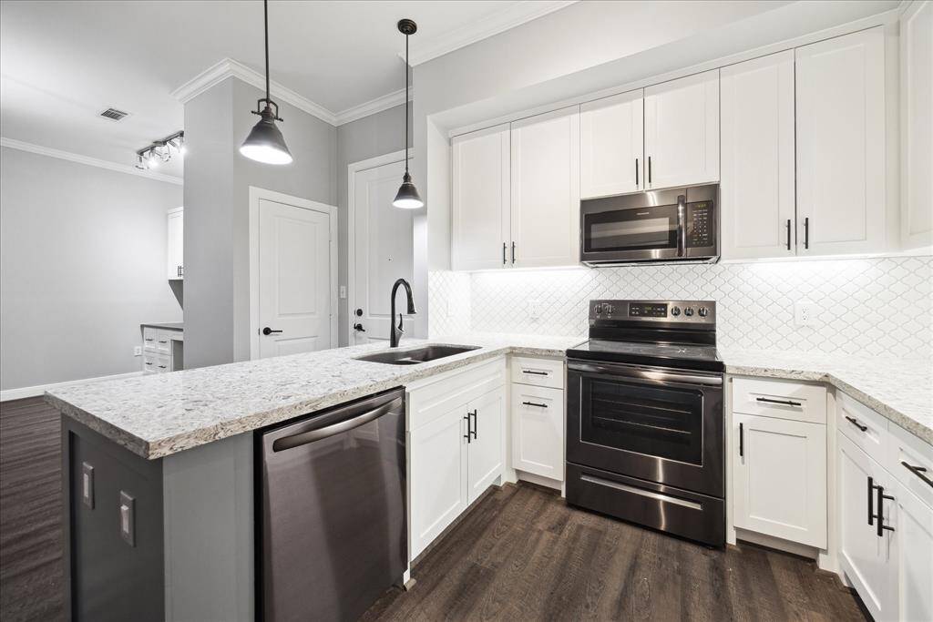 Beautiful Kitchen with cabinets that go all the way up  to the fur-down.