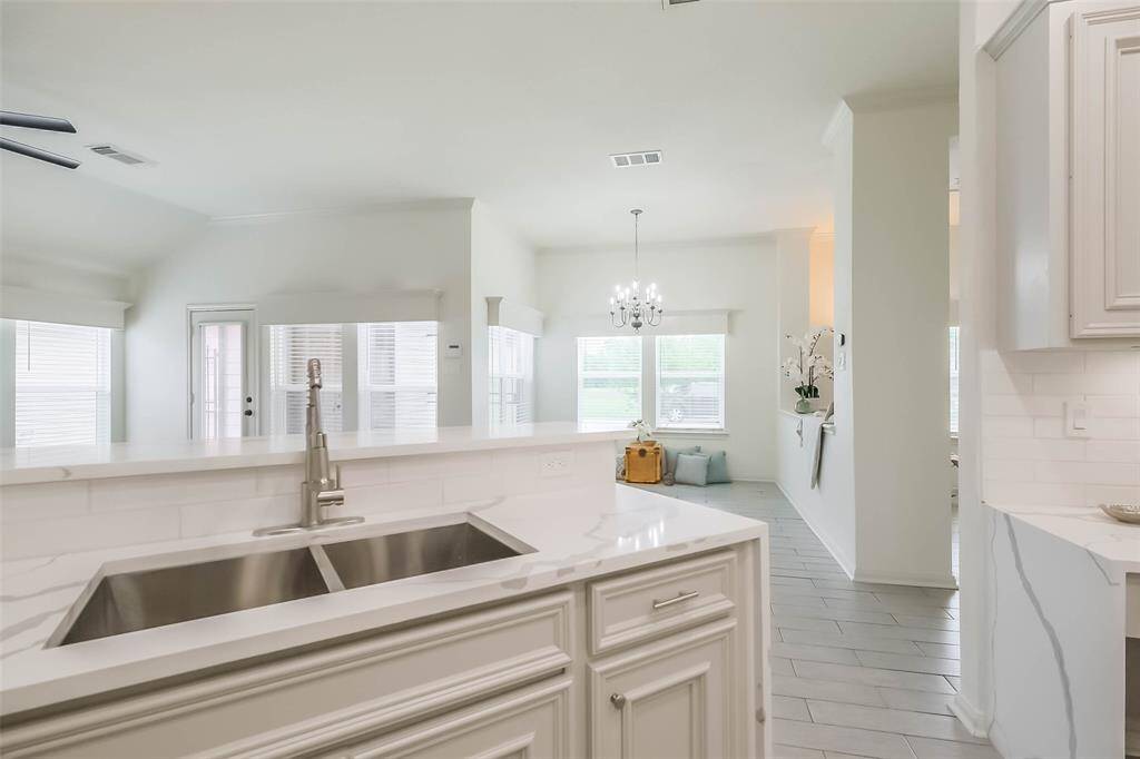 Standing in the dining area, you see the stunning updated kitchen and family room. The kitchen has all new quartz waterfall countertops.